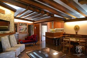 a living room with a couch and a table at Saint Michel Chalets in Al Arz