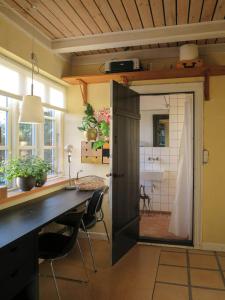 an open door in a room with a desk and chairs at Experience The Sea And Starling Murmuration in Kolby Kås