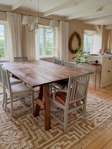 a large wooden table in a kitchen with chairs at Charming Farmhouse With Open Spaces Near Österlen in Löderup