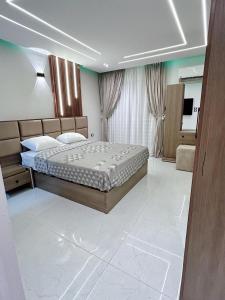 a bedroom with a large bed in a room at Comfy 2-Bedrooms Apartment in Cairo Sheraton airport in Cairo
