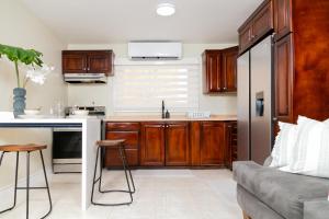 a kitchen with wooden cabinets and a stainless steel refrigerator at Spacious Comfort - Kingston in Kingston