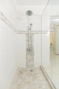 a shower with a glass door in a bathroom at Spacious Comfort - Kingston in Kingston