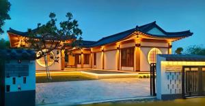 a house with a gate in front of it at Krajokkaew Inyeon Khao Yai in Ban Khlong Yang