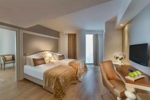 A bed or beds in a room at Aska Lara Resort & Spa Hotel