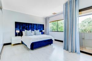 a bedroom with a large bed and a large window at Baluwatu 10, Zimbali Estate by Euphoric Leisure in Ballito