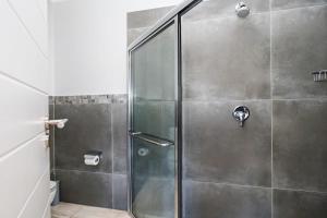 a shower with a glass door in a bathroom at Baluwatu 10, Zimbali Estate by Euphoric Leisure in Ballito