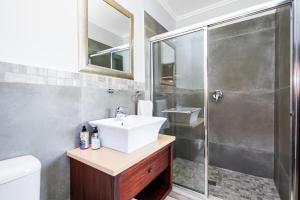 a bathroom with a sink and a shower at Baluwatu 10, Zimbali Estate by Euphoric Leisure in Ballito