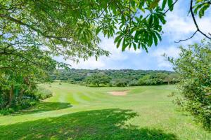 a view of a golf course with a green at Baluwatu 10, Zimbali Estate by Euphoric Leisure in Ballito