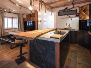 a kitchen with a large island with a wooden counter top at Luxury Larch Loft in Tesido