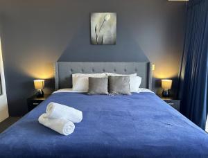 ゴールドコーストにあるSurfers Apartment Beach Mountain View Sleeps 6の青いベッドと2枚のタオルが置かれた寝室 +23枚の写真