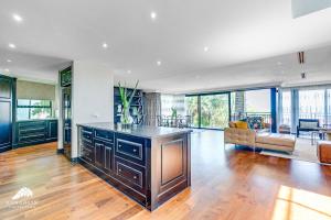 a kitchen with a large island in a living room at Phezulu Villas 2, Zimbali Estate by Euphoric Leisure in Ballito