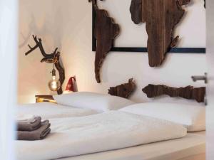 a bedroom with two beds and antlers on the wall at Luxury Larch Loft in Tesido +19 photos