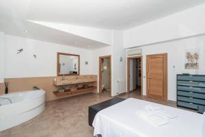 a large bathroom with a tub and a sink at Villa Marioma in Cala de Sant Vicent +34 photos