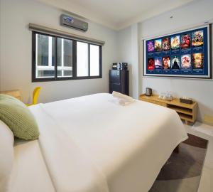 a bedroom with a large white bed and a window at Diamond crown 2 Hotel in Ho Chi Minh City