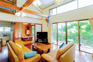a living room with a couch and a table at Peace Branch in Yonabaru