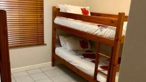 a couple of bunk beds in a room at Fairways 5, Zimbali Estate by Euphoric Leisure in Ballito +11 photos