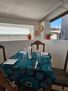 a table with a blue and green table cloth on it at Vivi Cafe B&B in Zanzibar City