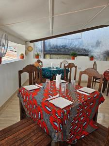 a dining room with a table with a red table cloth at Vivi Cafe B&B in Zanzibar City +31 photos