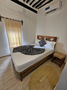 a bedroom with a large bed with a rug at Vivi Cafe B&B in Zanzibar City +31 photos
