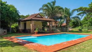 a swimming pool in the yard of a house at Fairways 5, Zimbali Estate by Euphoric Leisure in Ballito