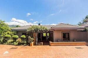 a house with a brick driveway in front of it at Aleah, Cathkin Estates by Euphoric Leisure in Champagne Valley
