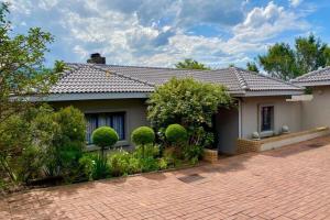 a house with a brick driveway in front of it at Aleah, Cathkin Estates by Euphoric Leisure in Champagne Valley +25 photos