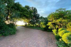 a brick road with trees on the side of it at Aleah, Cathkin Estates by Euphoric Leisure in Champagne Valley