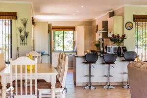 a kitchen and living room with a table and chairs at Aleah, Cathkin Estates by Euphoric Leisure in Champagne Valley