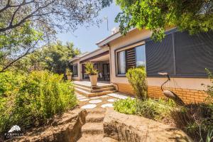 a home with a stone path leading to a house at Aleah, Cathkin Estates by Euphoric Leisure in Champagne Valley