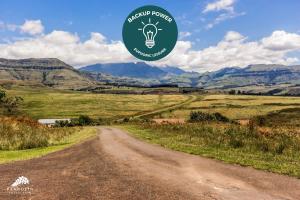 a dirt road with a green circle with a light bulb at Aleah, Cathkin Estates by Euphoric Leisure in Champagne Valley
