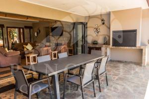 a dining room and living room with a table and chairs at Aleah, Cathkin Estates by Euphoric Leisure in Champagne Valley