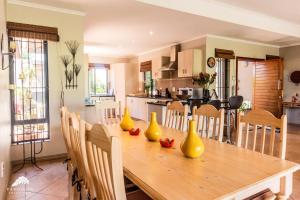 a wooden table with yellow vases on it in a kitchen at Aleah, Cathkin Estates by Euphoric Leisure in Champagne Valley