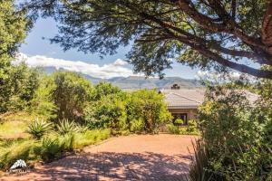 a house with a driveway in front of a house at Aleah, Cathkin Estates by Euphoric Leisure in Champagne Valley