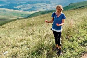 a woman standing on top of a grassy hill at Aleah, Cathkin Estates by Euphoric Leisure in Champagne Valley