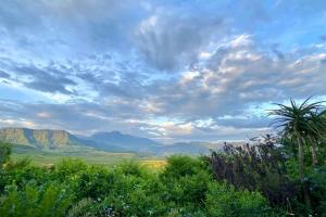 a view of the mountains under a cloudy sky at Aleah, Cathkin Estates by Euphoric Leisure in Champagne Valley