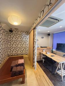 a room with a wooden table and a wooden bench at househotel上野 入谷 in Tokyo