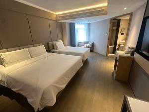 Postel nebo postele na pokoji v ubytování Atour X Hotel Dalian Xinghai Square Xi'an Road