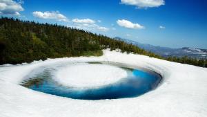 a large pool of blue water in the snow at ANA Crowne Plaza Resort Appi Kogen by IHG in Hachimantai