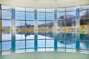 a swimming pool with a reflection in the water at ANA Crowne Plaza Resort Appi Kogen by IHG in Hachimantai