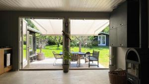 a kitchen with a patio with a table and chairs at Family Home By Scenic Coast In North Zealand in Vejby