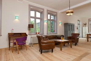 a living room with a couch and a table and chairs at Spacious Apartment With Terrace And Garden View in Walow +20 photos