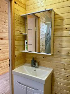 a bathroom with a sink and a mirror at Tasmal Yurt Camp in Tong