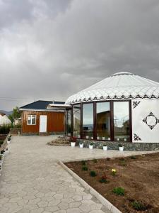 a large building with a domed roof with windows at Tasmal Yurt Camp in Tong +18 photos