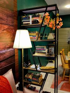 a room with a lamp and a book shelf with books at #MyHillsideHideaway at Quintet, Cameron Highlands in Tanah Rata