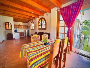 a dining room with a table with a colorful table cloth at Apartamentos Panajachel in Panajachel