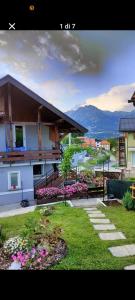 a view of a house with a yard with flowers at Giardino Segreto in Valdenogher