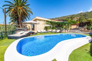 a swimming pool in the yard of a house at Villa Isabel Sol in Adeje