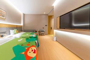TV a/nebo společenská místnost v ubytování Guyuan Golden Garden Hotel