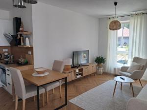 a kitchen and living room with a table and chairs at Apartmán u Teuška in Krásno nad Kysucou