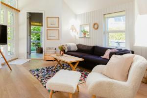 a living room with a couch and a table at An Intimate Get-Away By The Sandvig Bay in Haderslev
